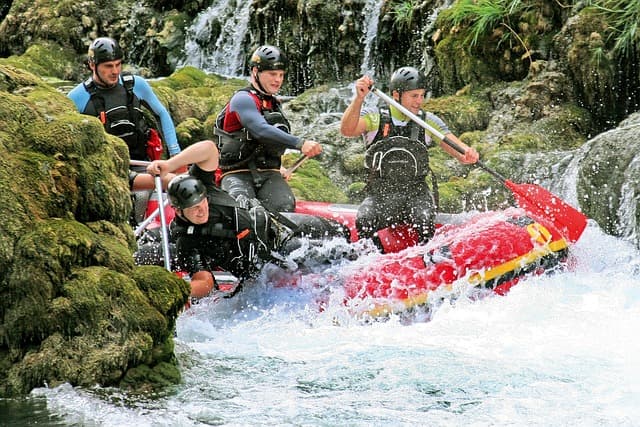 4 rafters figuring out how to get out of a rocky waterfall